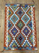 A hand-knotted Chobi kilim rug, central panel with repeating geometric and diamond motifs, burnt