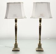A pair of Danish Lene Bjerre square tapered base brass table lamps with a pair of white cotton
