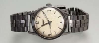 A vintage Longines stainless steel manual wind wristwatch with silvered dial and roman numerals at