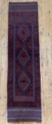 A hand-knotted Meshwani runner, central field with three diamond medallions enclosed within a banded