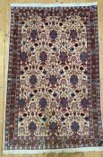 A hand-knotted Persian Veramin rug, central field with stylized animals and scrolling foliate