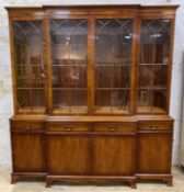 A reproduction yew breakfront bookcase by Bradley Furniture, moulded cornice over four astragal