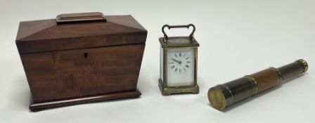 A Victorian mahogany tea caddy of sarcophagus form, raised on four bun feet, lacking one cover (h.