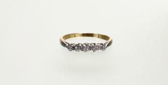 An 18ct gold and white metal mounted ring set five graduated transitional cut diamonds, centre stone