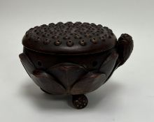 A 20thc Chinese terracotta incense burner, with lotus flower and leaves moulded to exterior, pierced