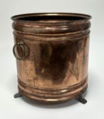 A McCintyre of Edinburgh copper jardiniere, raised on three paw feet with twin brass loop handles (