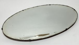 An Art Deco oval mirror, with scalloped edge border (l. 55.5cm)