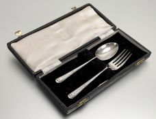 A Sheffield silver christening set comprising a fork and spoon: l. x 13cm engraved with the letter H