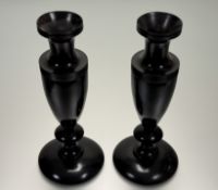 A pair of exotic hardwood baluster form vases, on circular base. (h-34cm) (2)