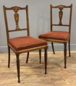 A pair of Edwardian inlaid rosewood side chairs, marquetry splat backs over red upholstered seats,