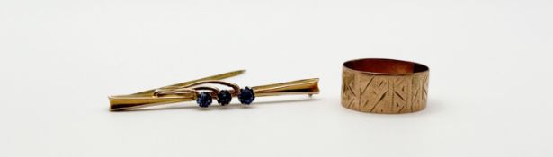 A 9ct gold bar brooch set three blue coloured paste stones: l. x 4cm 0.97g together with a reduced