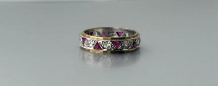 A 9ct gold yellow and white metal eternity style ring set ten pink triangular cut stones alternating