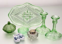 A nArt Deco 1930's green cut glass vanity set comprising a pair of candlesticks (h-16cm), a tray,