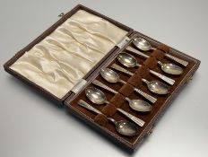 An Edinburgh silver set of eight coffee spoons with Art Deco inspired terminals: l. x 9.5cm