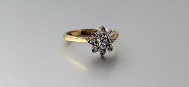 An 18ct gold diamond cluster ring, the central old mine cut stone approximately 0.05ct within a