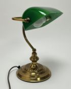 A contemporary 1920s style gold metal and green glass bankers table lamp with adjustable shade,