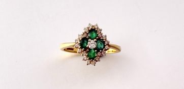 An 18ct gold emerald and diamond cluster ring with a central round brilliant cut diamond