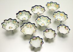 A trio of Nippon three footed scallop edges decorative dishes decorated with pink roses and blue rim