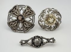 A silver Celtic knot panel scalloped brooch set with facet cut round smoky quartz, approximately