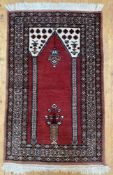 A modern hand-knotted Afghan prayer rug, central panel with twin columns and stylized flowers in a