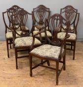 A set of eight reproduction mahogany dining chairs, Hepplewhite-style backs and floral drop-in