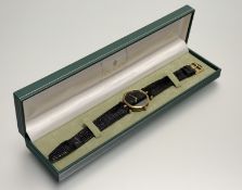A Vintage Gucci gilt metal black dial quartz wrist watch on original Gucci strap and tang buckle: d.
