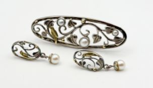 A modern Edinburgh silver and yellow metal bird and leaf oval open work brooch set with three