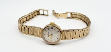 A vintage Omega 9ct gold wristwatch with silver dial and roman numerals at the quarters: d. x 1.