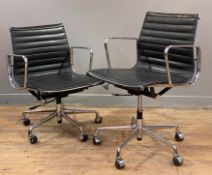 After Charles Eames, a pair of reproduction Eames EA117 office chairs, black leather seats and