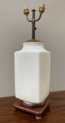 A Chinese vase style table lamp, white rectangular sides with script decoration, twin light fittings