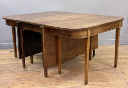 A George III mahogany three-part dining table, twin D-ends with drop-leaf gate-leg centre section,
