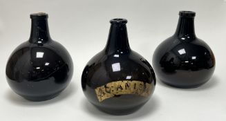 A collection of three early 19thc green glass apothecary bottles of onion form, one with gilt