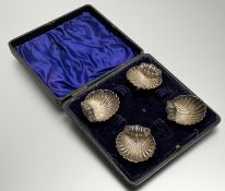 A Victorian Birmingham silver set of four shell table salts raised on three ball supports: h. x 1.