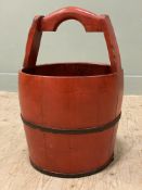 A modern Chinese wooden bucket, red lacquered finish with arched handle to top: H. 53cm D. 38cm