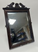 A Georgian style carved mahogany wall-hanging mirror, with bevelled glass plate and applied carved