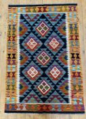 A hand-knotted Maimana kilim rug, central panel with repeating geometric and diamond motifs, burnt