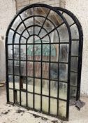 A single large cast-iron framed arched garden mirror of astragalled window form (a/f). 186cm by
