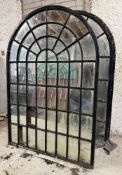 A pair of large cast-iron framed arched garden mirrors of astragalled window form (a/f). Each