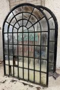 A pair of large cast-iron framed arched garden mirrors of astragalled window form (a/f). Each