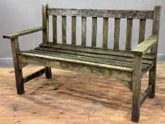 A weathered wooden slatted garden bench. 80cm by 129cm by 56cm.