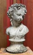 A composition stone bust of a young girl in 18th century style, modelled with vine leaves and grapes