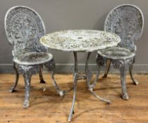 A pair of grey-painted cast metal garden chairs in 19th century style, with circular table en suite.