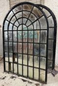 A pair of large cast-iron framed arched garden mirrors of astragalled window form (a/f). Each
