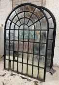 A pair of large cast-iron framed arched garden mirrors of astragalled window form (a/f). Each