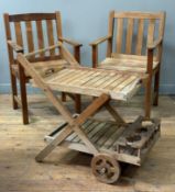 A pair of Rowlinson teak slatted garden armchairs, together with a teak two-tier garden drinks