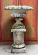 A large painted stoneware centrepiece campana garden urn, standing on a (possibly associated) fluted