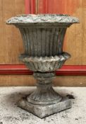 A painted stoneware / terracotta campana garden urn, reeded bowl, on a square base (in two