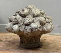 A composition stone garden ornament of a basket of fruit. 30cm by 35cm.