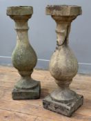 A pair of weathered composition stone balusters (a/f), each on a square base. Height 68cm