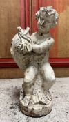 A painted cast-iron garden figure of a putto wrestling a sea creature. 53cm.